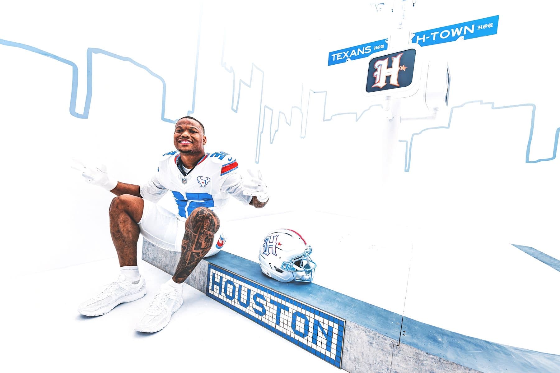 David Montgomery posing in a Houston Texans alternate uniform