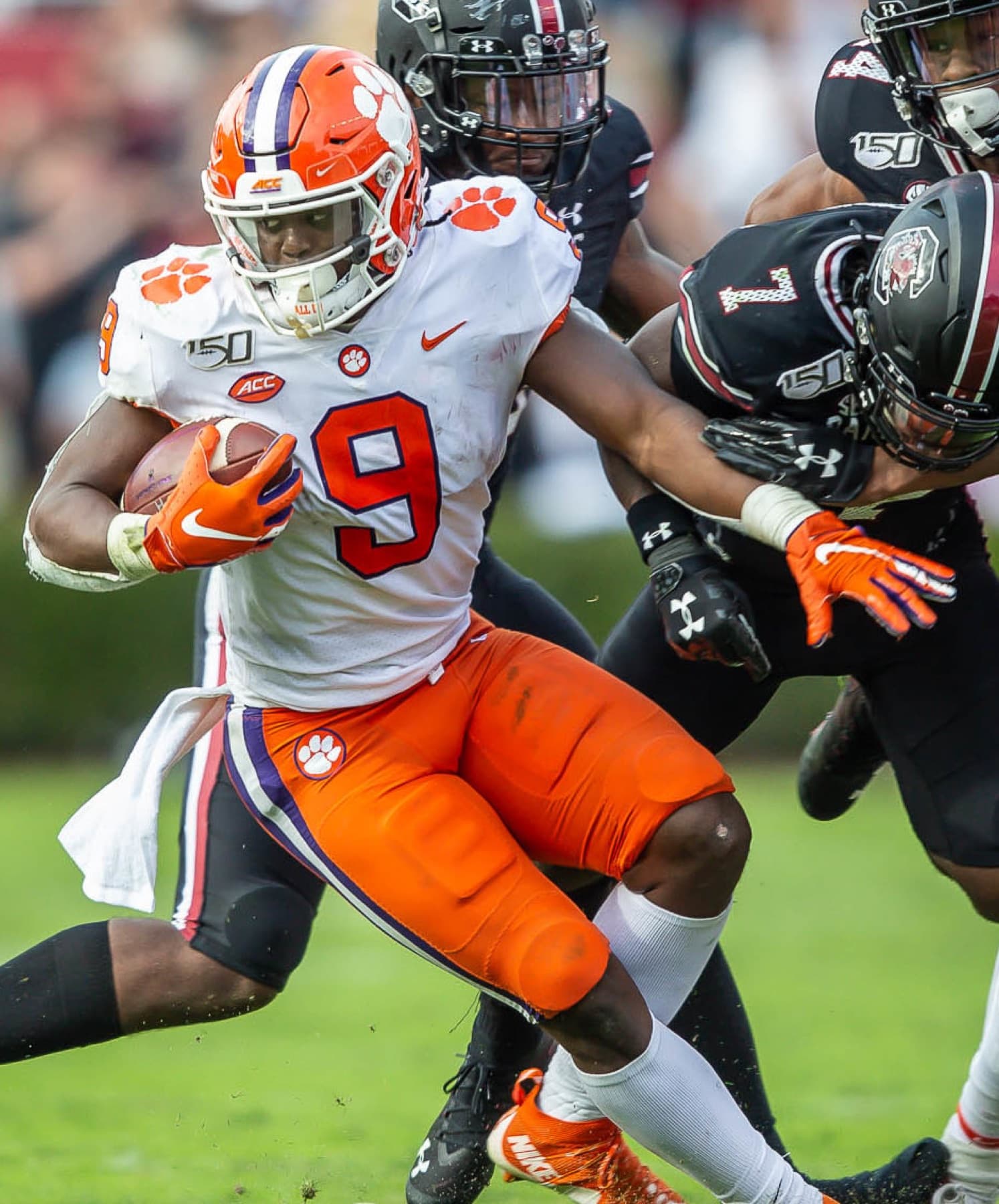 Travis Etienne carrying the ball for Clemson against South Carolina
