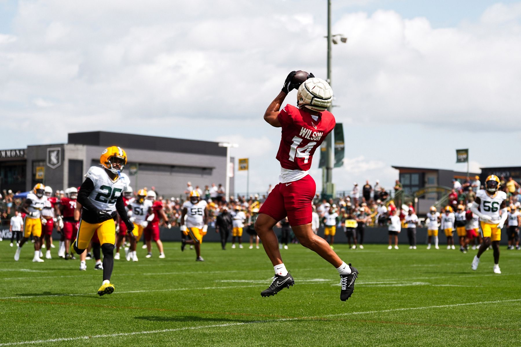Michael Wilson leaping for a catch at the Cardinals' joint practice with the Packers